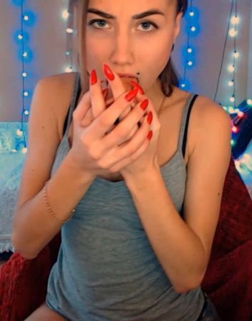 Cute teen camgirl with red nails deepthroating a dildo during a live webcam show
